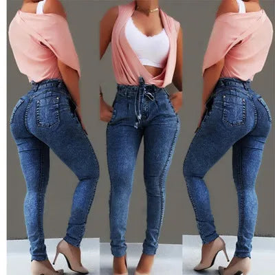 Pair of blue fringed jeans with a distressed hem laid flat, showing cowboy fabric texture.