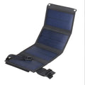 Foldable solar panel in black colour, folded to compact size for portability