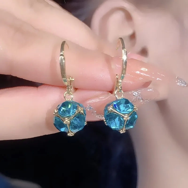 Geometric rose design women's electroplated copper earrings shown in one of the available colour variants.