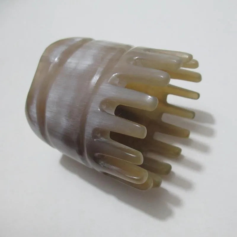 Black buffalo horn comb with wide teeth and pointed tip for scalp massage