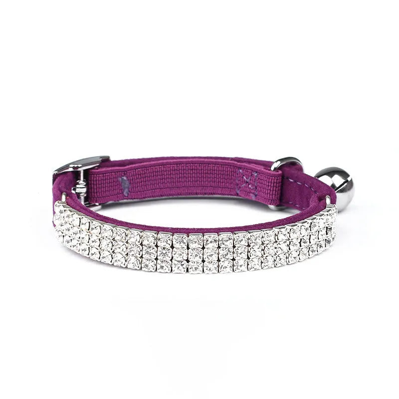 Red velvet cat collar with a line of sparkling rhinestones, showing the adjustable buckle.