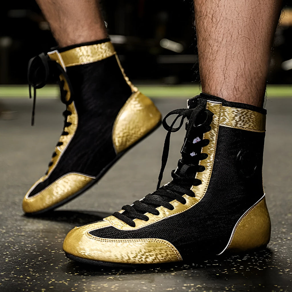 Professional black and gold mesh boxing shoes with a non-slip rubber sole for indoor training.