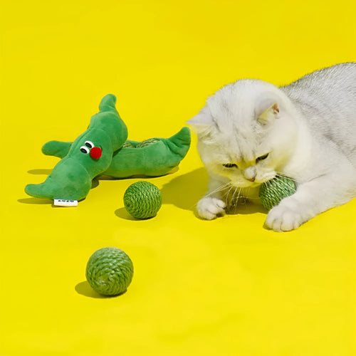 Three green sisal rope cat toy balls with rustling soundstone next to pea pod storage bag
