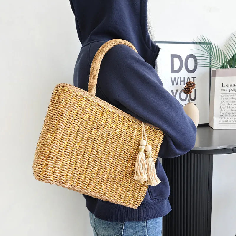 Handmade woven paper straw bag with double shoulder straps in gold and natural tones