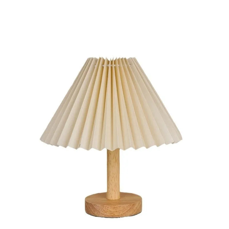 Vintage pleated umbrella-shaped USB bedside lamp with remote control on a wooden table.