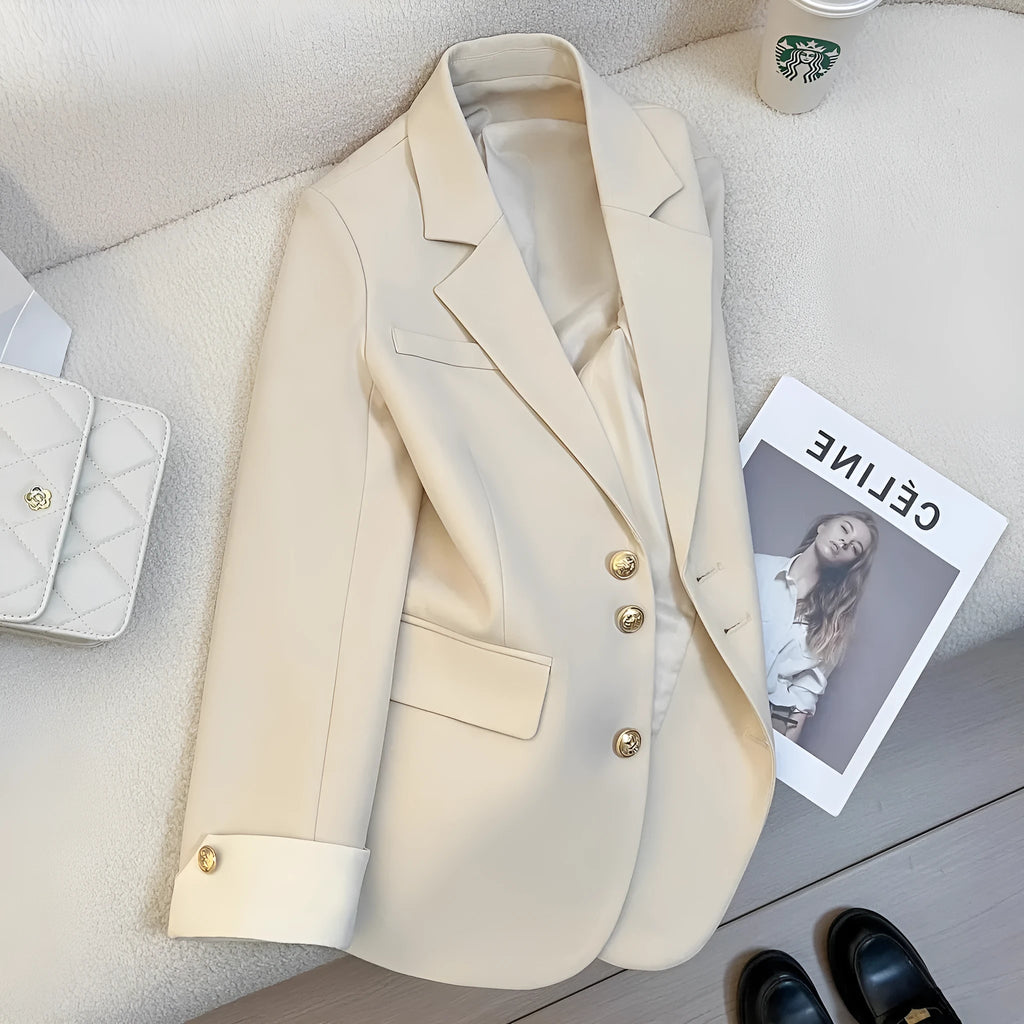 Korean-style loose fit women's coat in milky white, showing long sleeves and pockets.