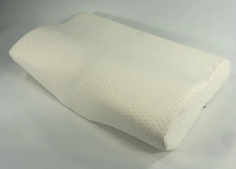 Butterfly-shaped blue memory foam cervical pillow on a bed.