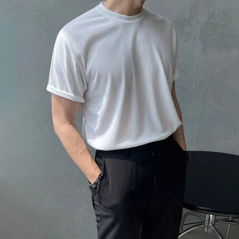 Men's slim fit cotton t-shirt in black with round neck and half sleeves on a model.
