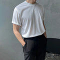 Men's slim fit cotton t-shirt in black with round neck and half sleeves on a model.