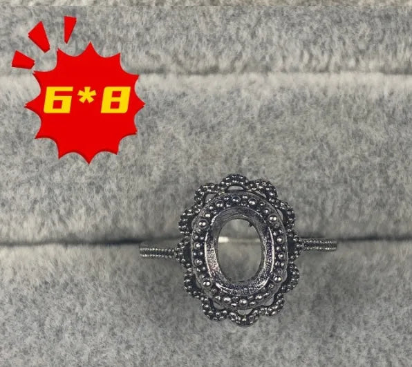 Oval denier open mouth ring with 6x8 main stone and five-pointed star design