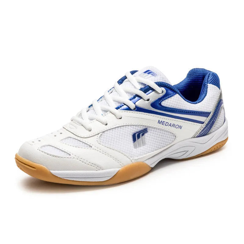 Table tennis training sneaker in white and blue with synthetic leather and mesh upper and lace-up front.