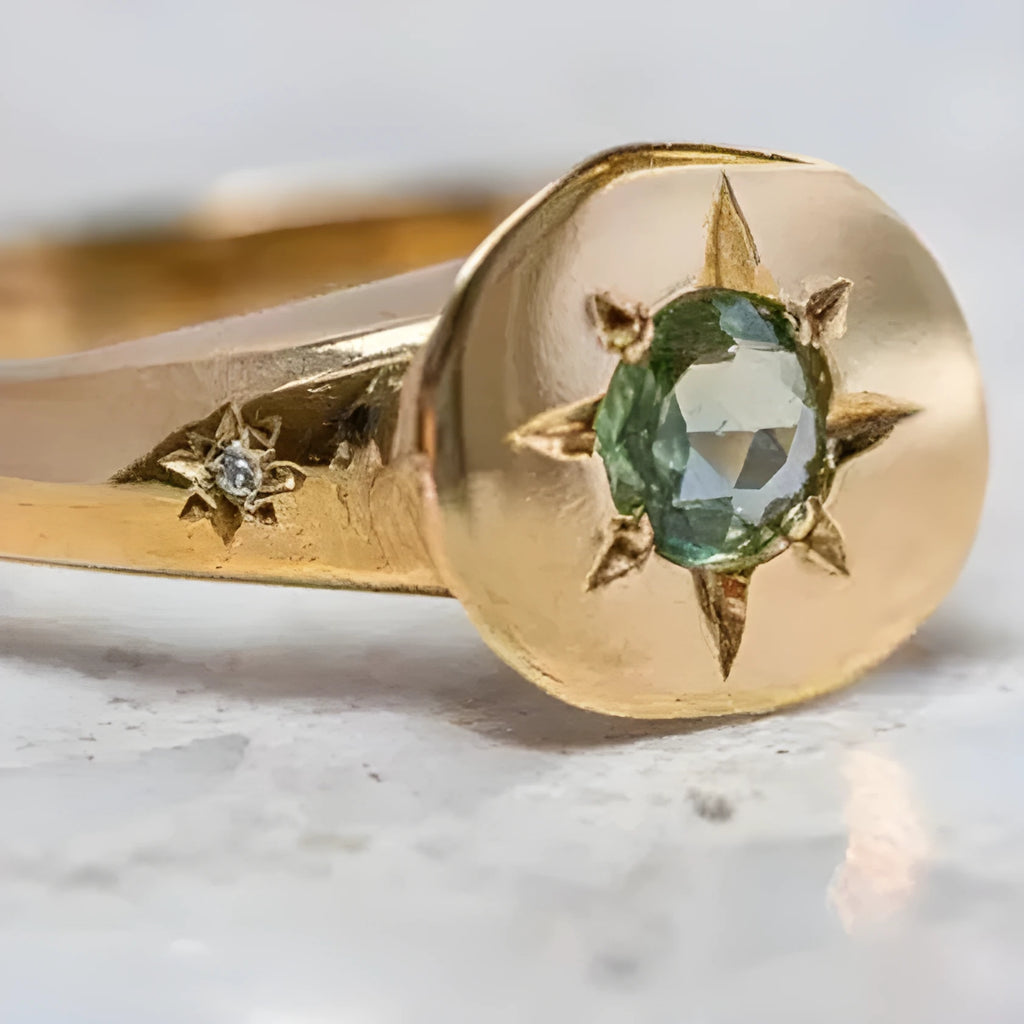 Golden adjustable ring with a star-shaped setting holding an oval zircon stone on a zinc alloy band.