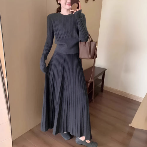 Dark grey knitted sweater and skirt set with a textured 3D pattern and artistic retro ethnic style.