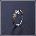 Close-up of a black gold plated crown ring on a finger, showing detailed copper modelling and a dark metallic finish.