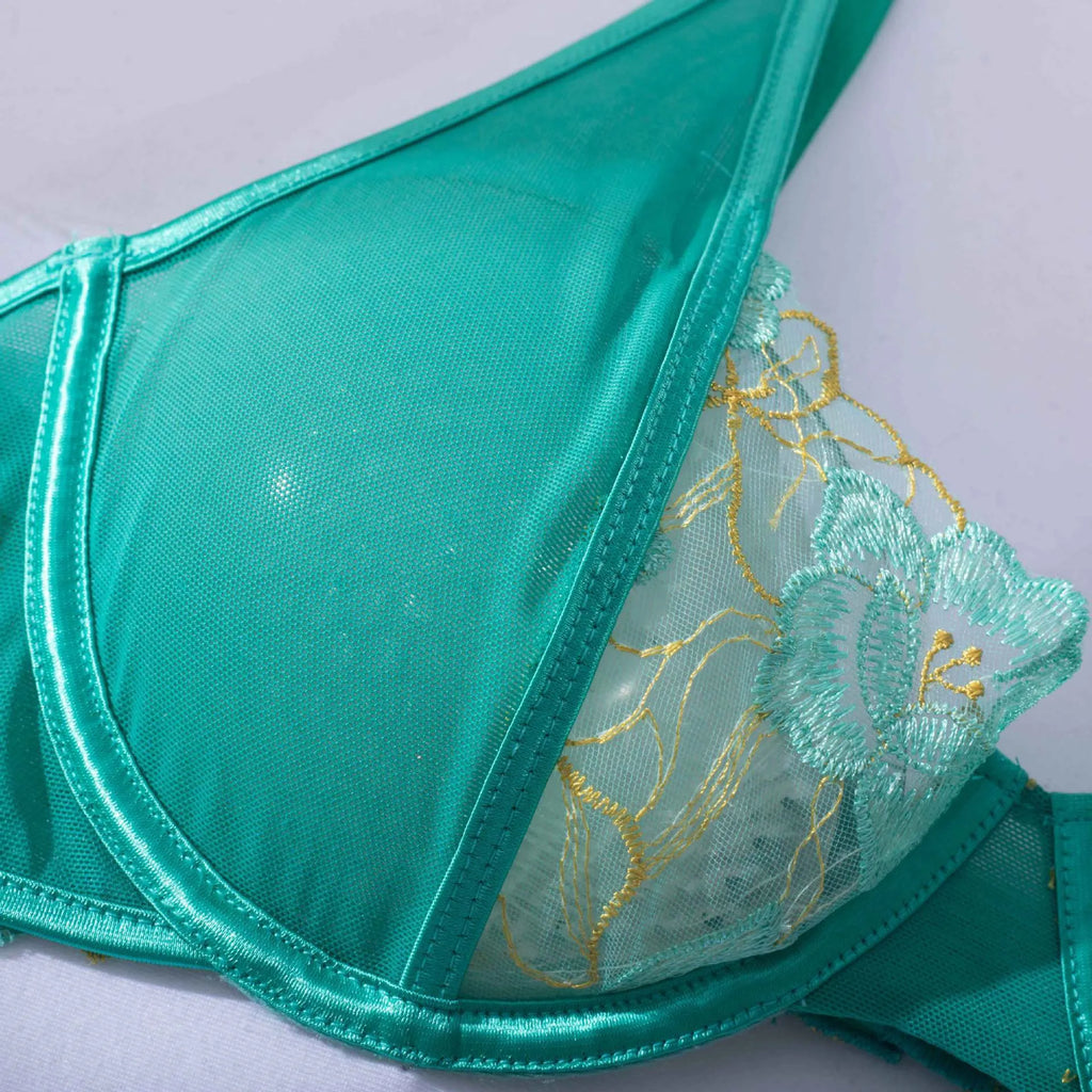 Light green women's embroidered bra and bikini set on a white background