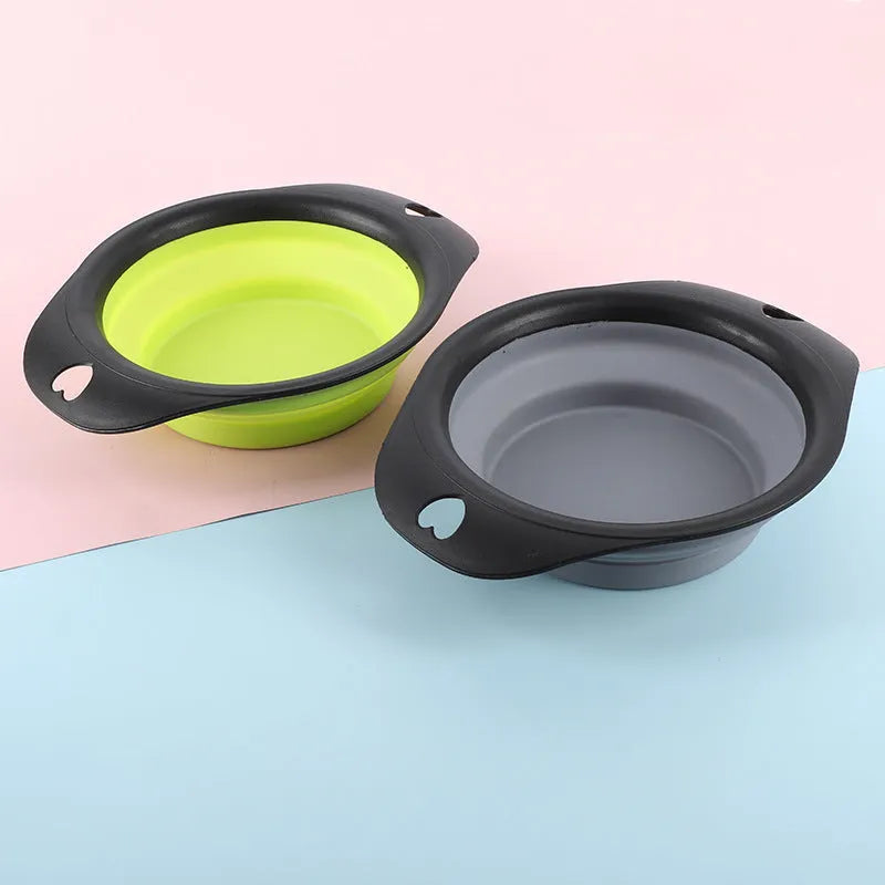 Black silicone pet bowl shown open and folded flat next to a dog leash.
