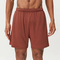 Men's double-layer quick-drying running shorts in brick red colour on a mid waist.