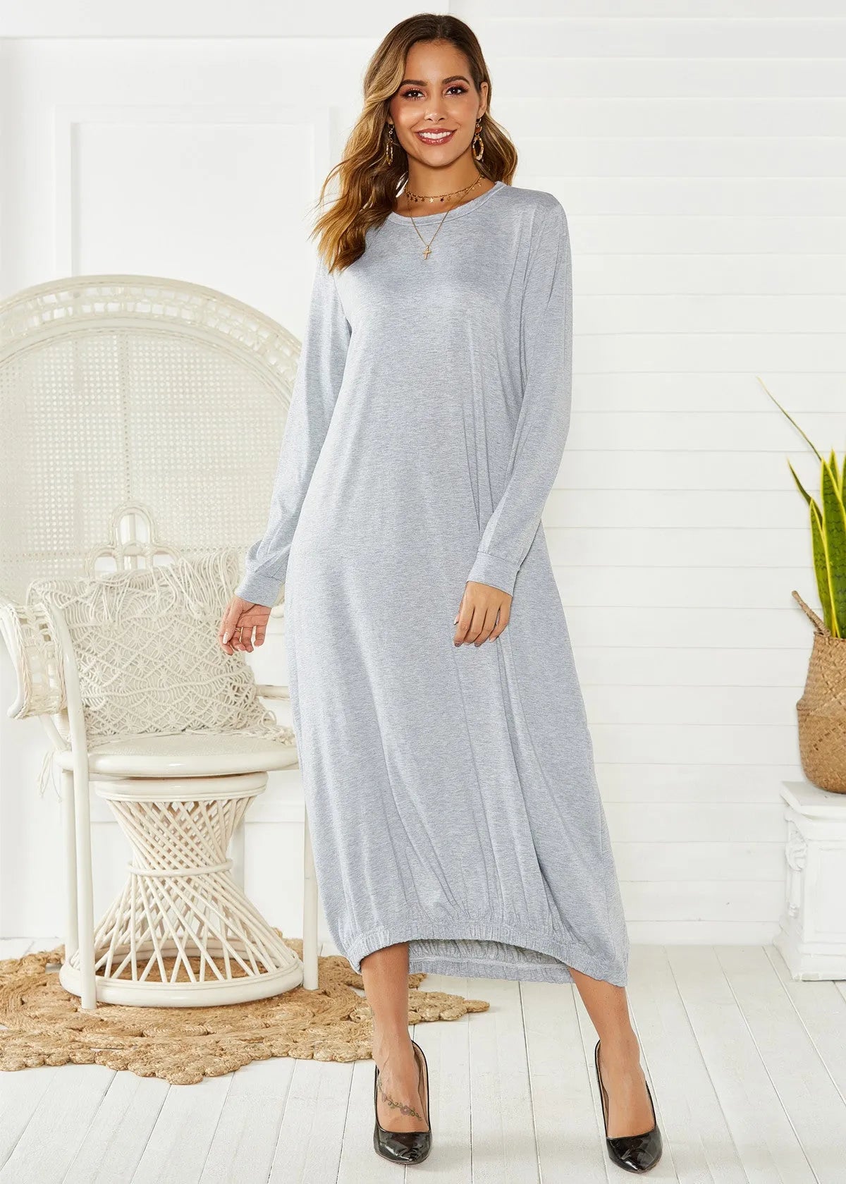 Black lace-up crew neck lantern dress on a hanger, showing loose long fit and threaded detail.