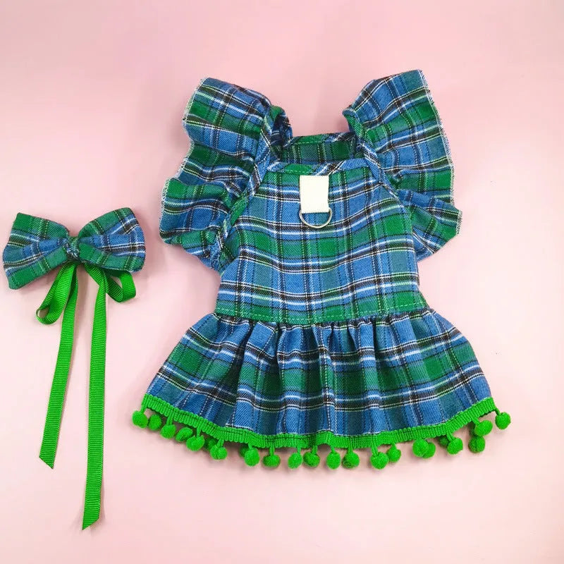 Red tartan Christmas skirt and matching head flower on a pet, with a jingling bell necklace accessory.