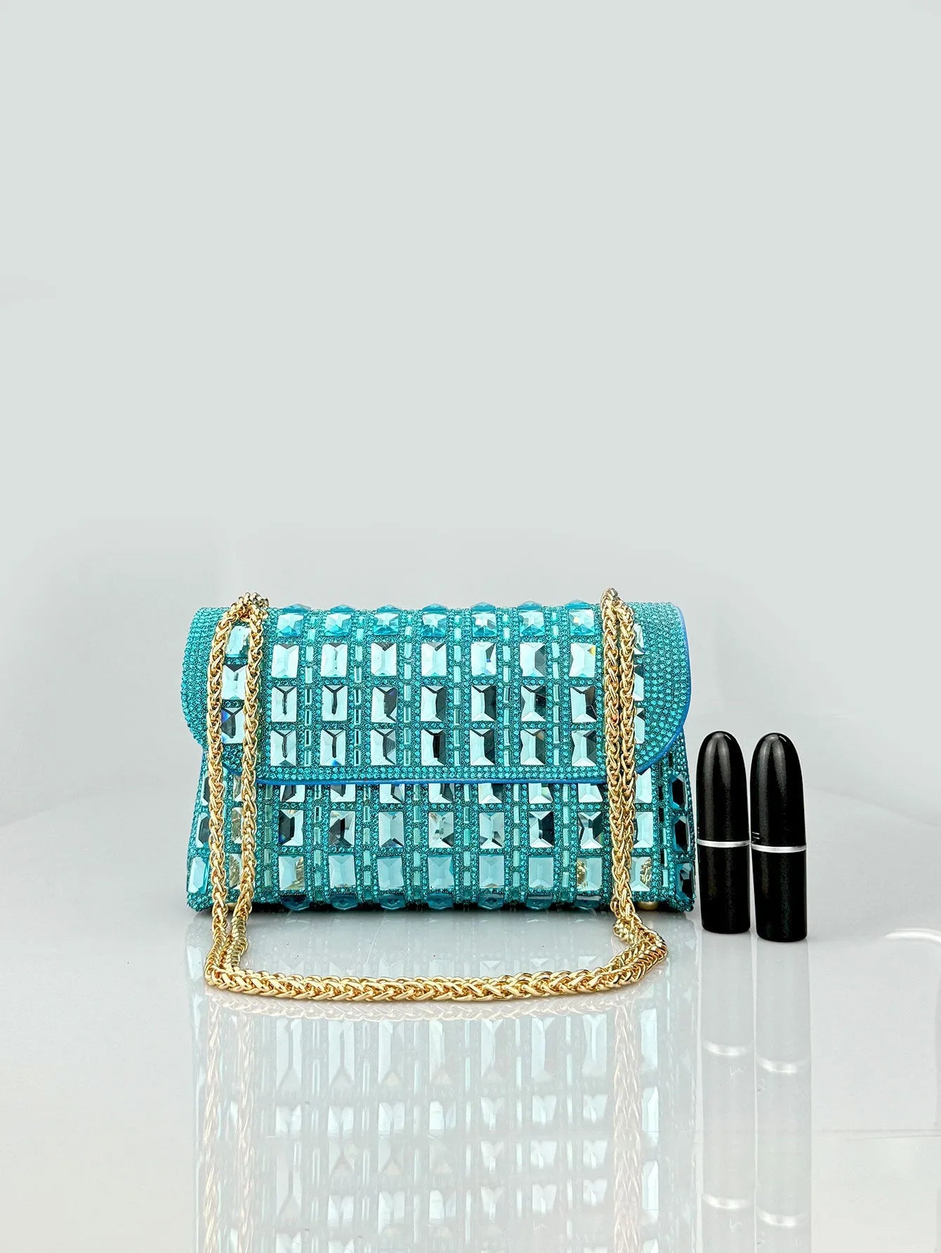 Silver rhinestone chain clutch purse with a horizontal square shape and open pocket.