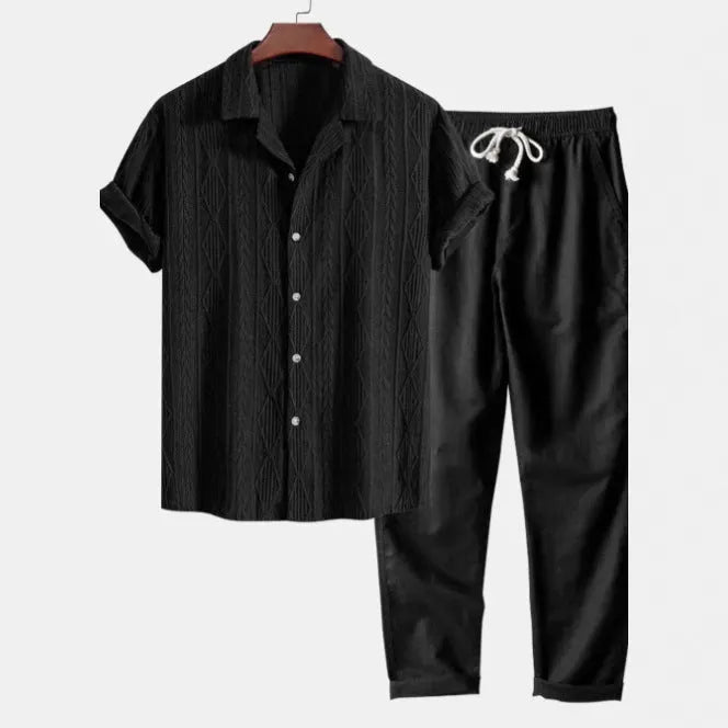 Man wearing a slim fit camouflage print short sleeve shirt and matching trousers casual suit