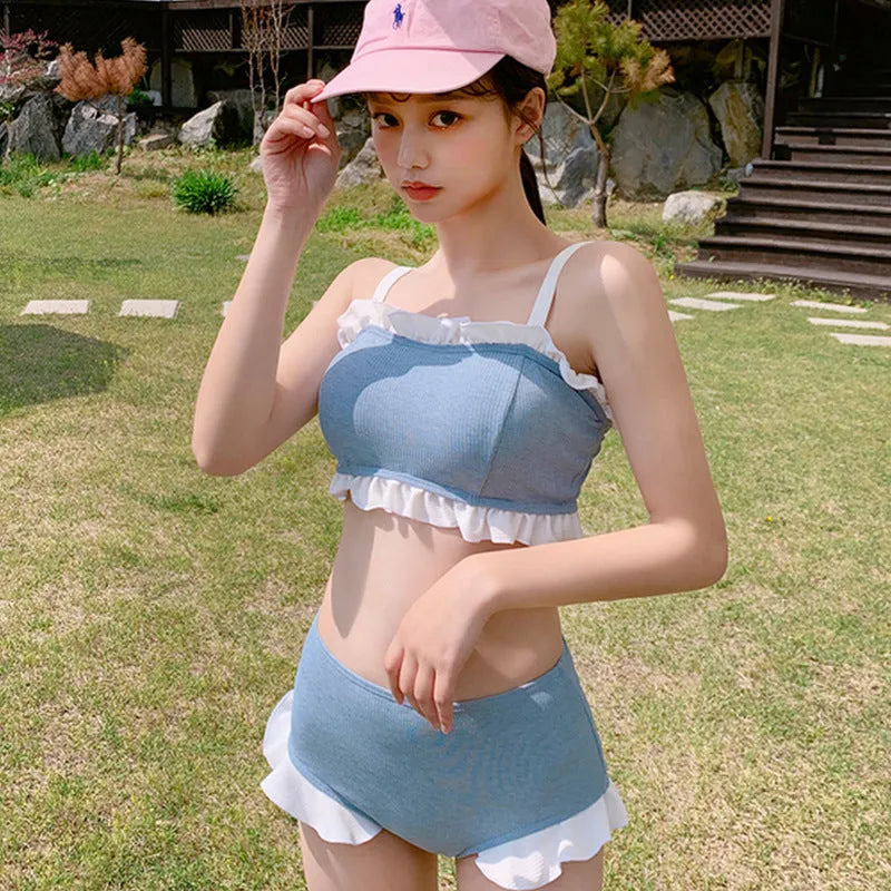Women's solid colour one-piece swimsuit with fashion suspender straps, conservative cut for swimming.