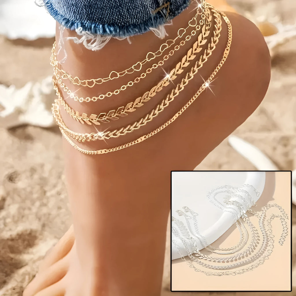 5Pcs bohemian airplane chain anklet set in gold alloy with heart-shaped links on white surface