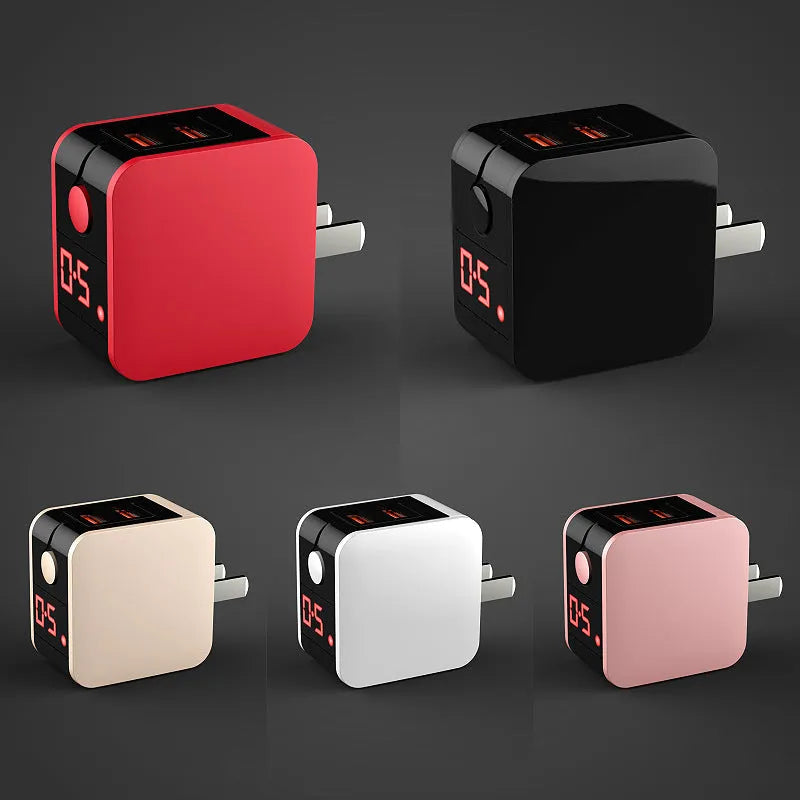 A black dual USB travel charger with a digital display showing '5V', plugged into a UK wall socket.