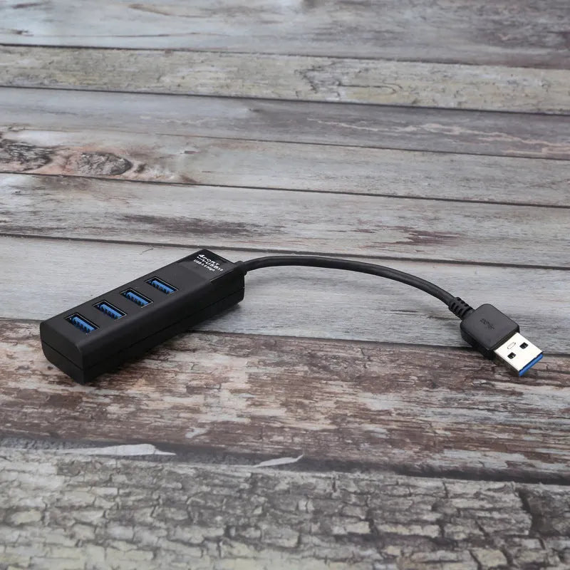Black USB 3.0 hub with four ports and 30cm cable for computer expansion