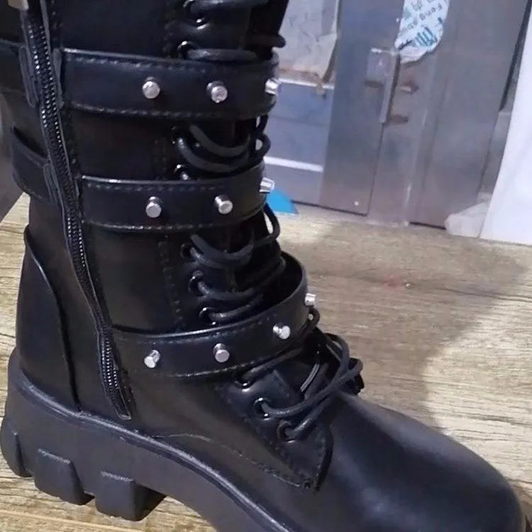 Black women's mid-calf knight boots with metal buckle detail and side zip on a white background