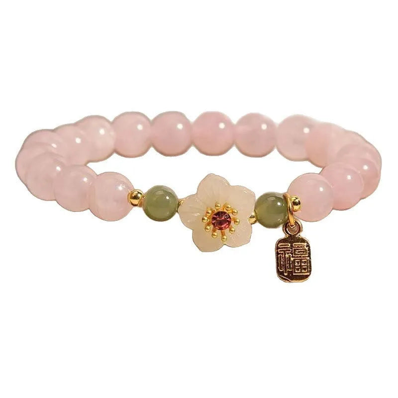 Crystal bracelet with Hetian jade beads showing peach blossom design, fruit charm, and camellia elements
