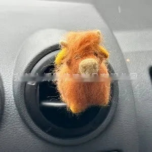 Scottish Highland Niutong air outlet clip in white plastic on a car dashboard vent