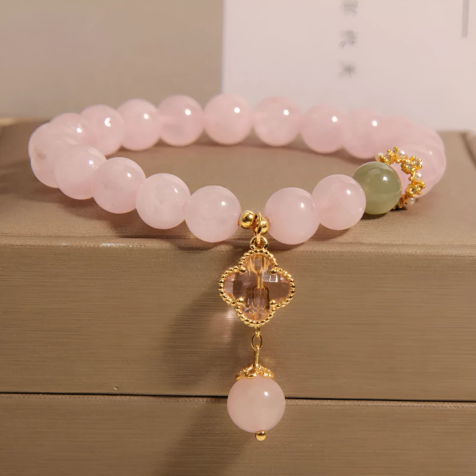 Pink crystal women's bracelet with four-leaf clover pendant and rhinestone details