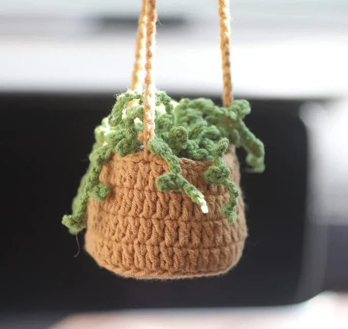 Green and white knitted wool car plant decoration with basin base and hanging rope