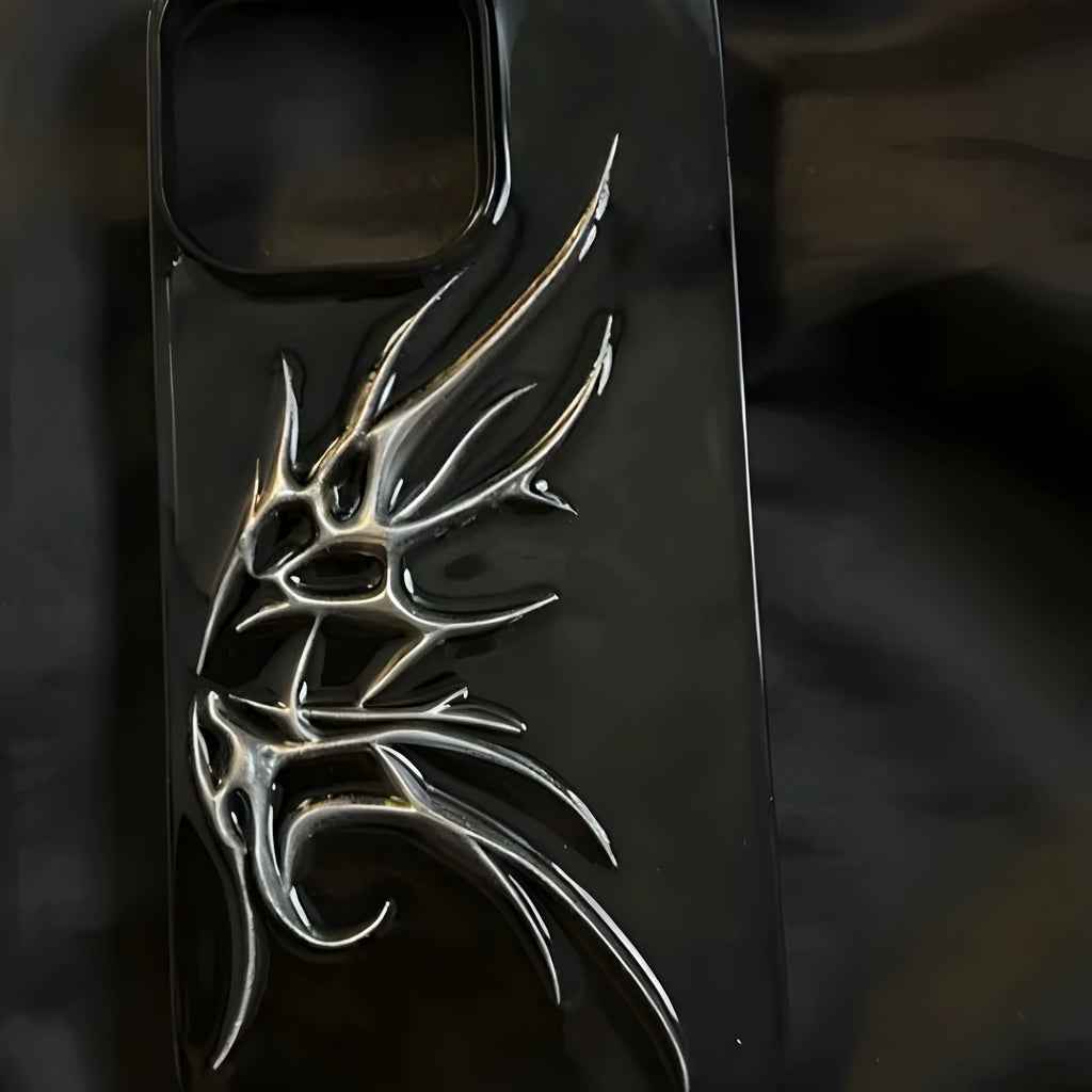 Black iPhone case with a blurred, three-dimensional wings design on the back.