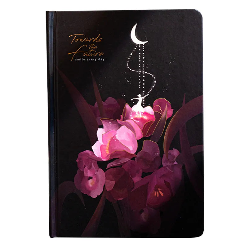 A5 notebook with luminous cover open to show pages filled with colour illustrations.