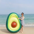 Green inflatable giant avocado pool float on water, showing its large 169x130cm size and smooth surface.