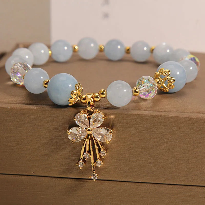 Normcore style crystal bracelet with amethyst and pearl charms on adjustable closure
