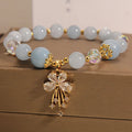 Normcore style crystal bracelet with amethyst and pearl charms on adjustable closure
