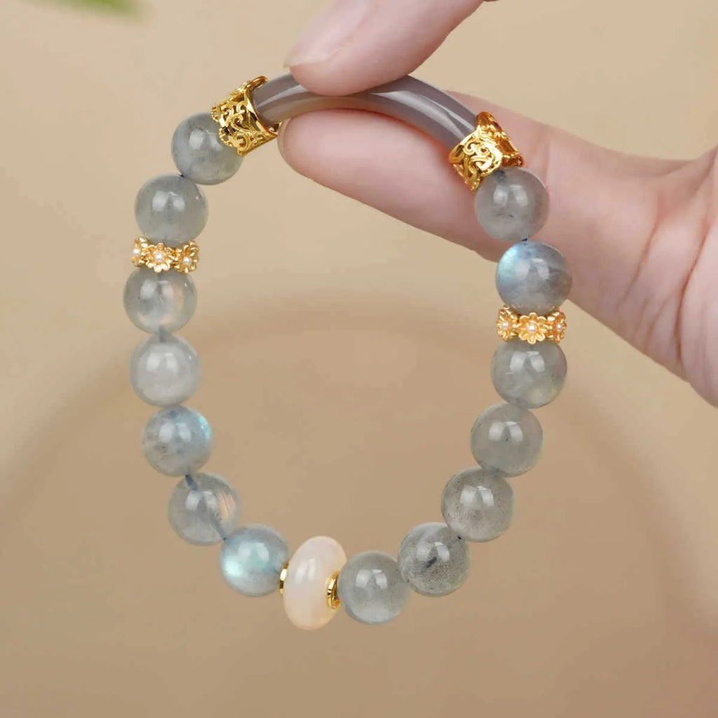 A simple gray moonstone bracelet for women with 8mm round beads on a white background.