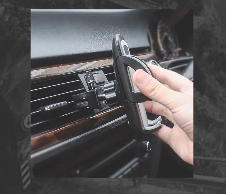Black universal mobile phone holder clipped to car air conditioning outlet