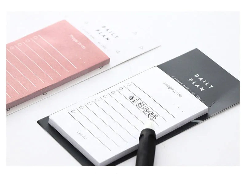 Pink and red schedule planning notepads showing 10cm by 6cm size and 80g paper.