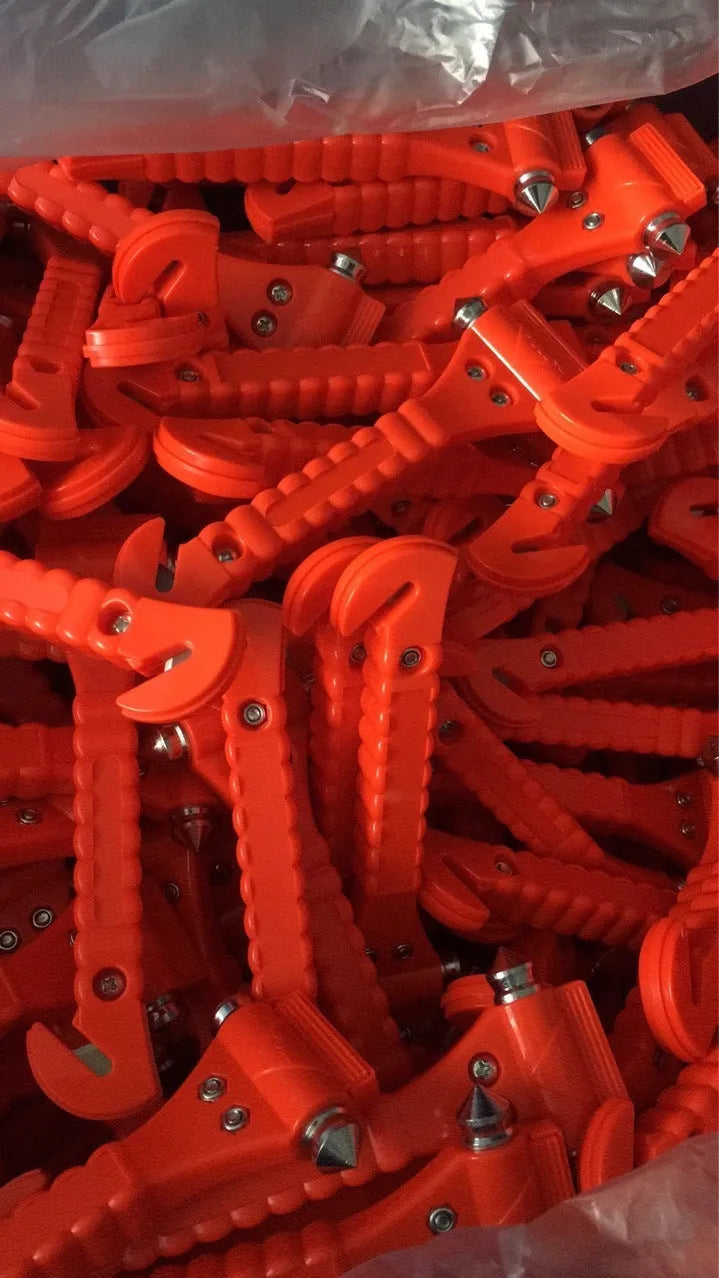 Red car emergency safety hammer with a carbon steel head and seatbelt cutter blade on an ABS plastic handle.