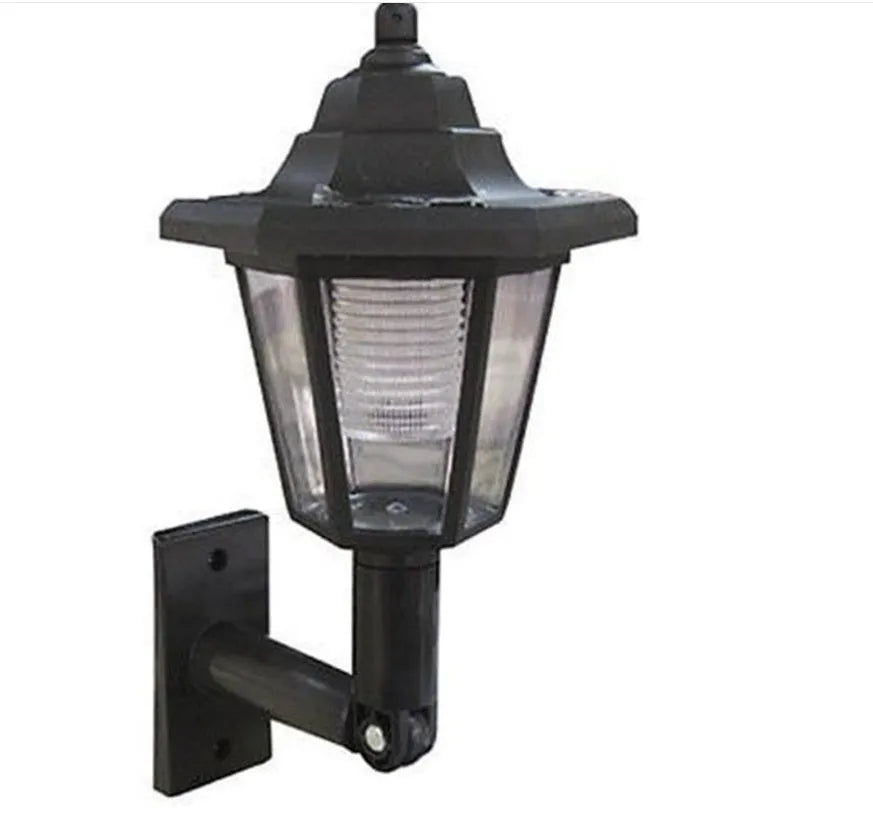 Black hexagonal solar wall light with solar panel for outdoor garden installation