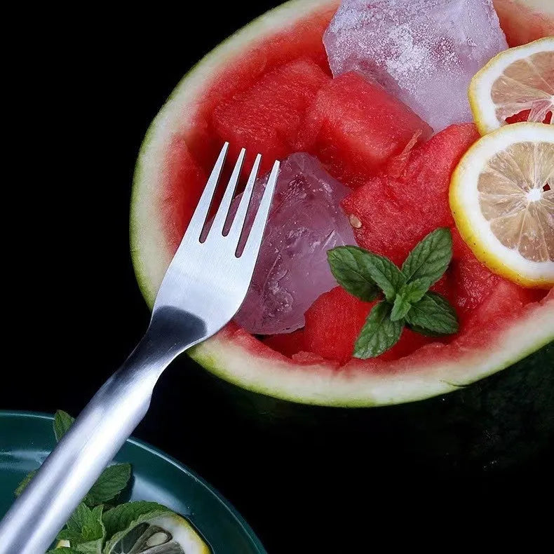 Stainless steel watermelon slicer and fork tool on a kitchen counter