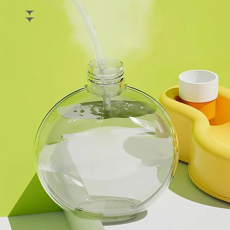 Green portable dog water bottle with pull-out drinking bowl, shown next to a dog.