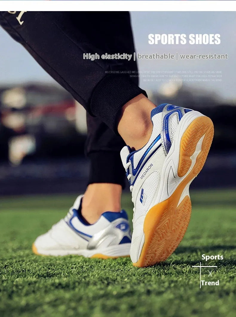 Table tennis training sneaker in white and blue with synthetic leather and mesh upper and lace-up front.