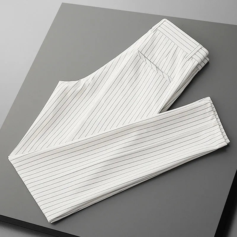 Man wearing thin striped loose-fit casual trousers in a drape style, shown in black and white colour options.