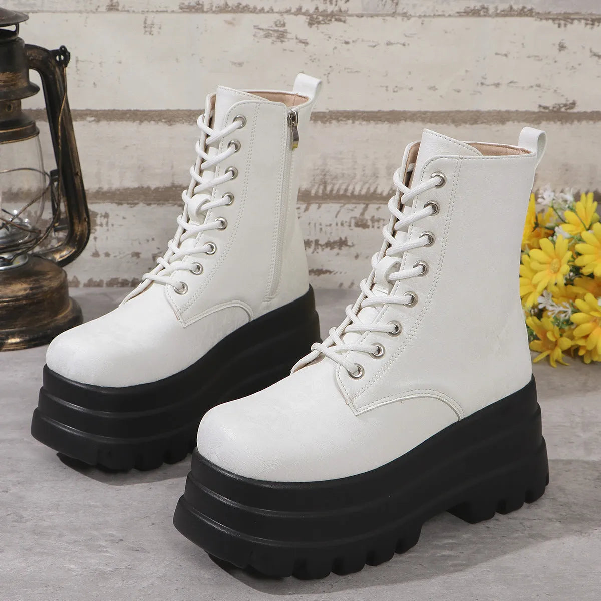 Women's black retro platform Martin boots with patchwork detail and side zipper.
