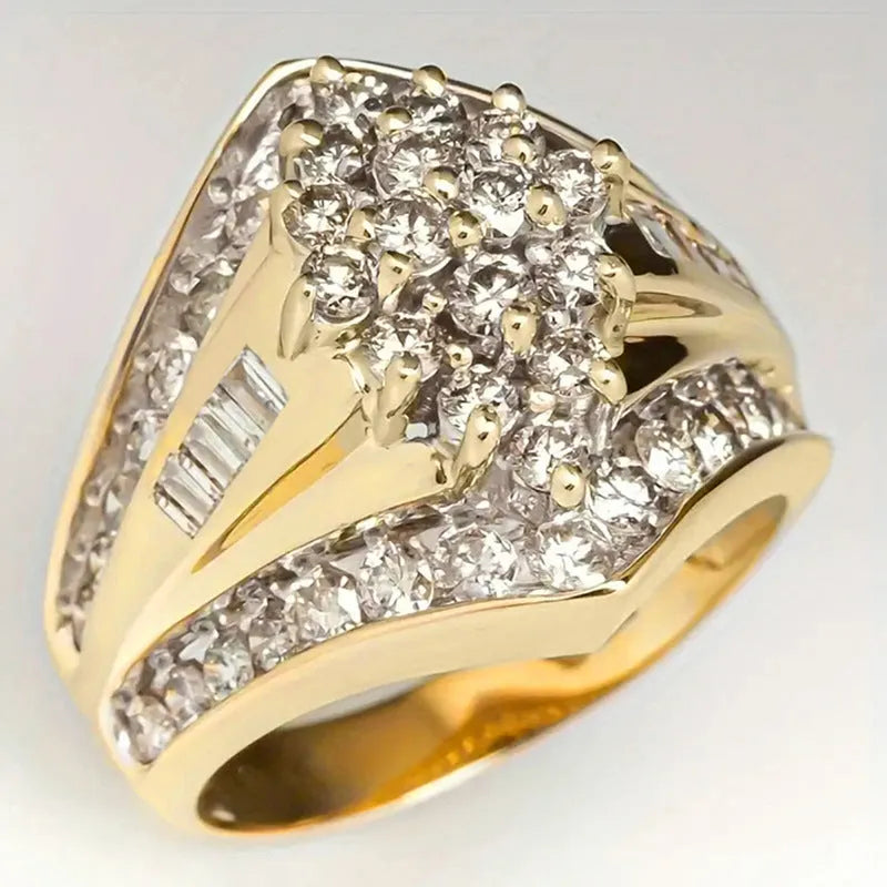 Geometric gold-coloured palace style fashion ring on a plain background, showing its angular design.